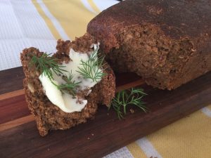 rye bread with piece broken off and served with butter and dill