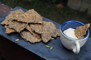 rye seed crackers with cup of hummus