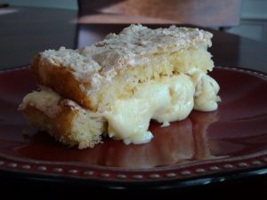slice of almond meringue cake with lemon cream